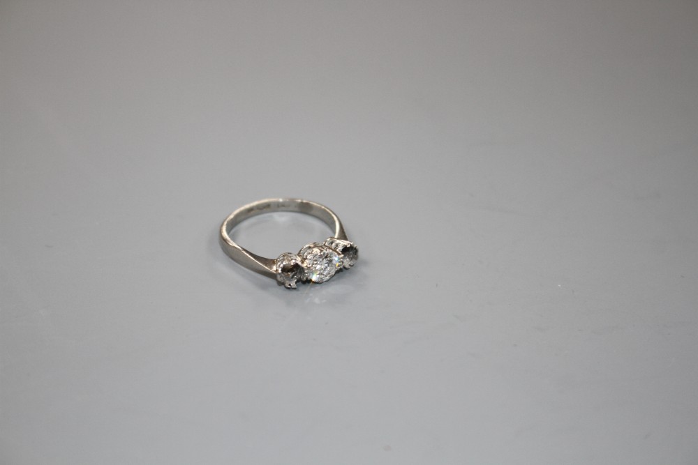 A white metal and single stone (ex three stone) diamond ring,